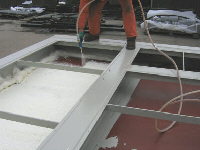 The first layer of foam is applied to the steel floor